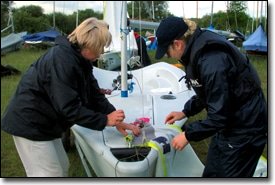 Students rigging a club boat